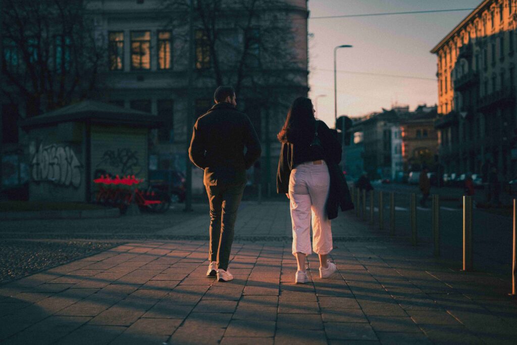 A couple walking together during sunset, finding ways on how to tell someone you like them.