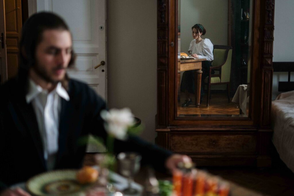 A distant woman reflected in a mirror at dinner, feeling deep resenting my husband’s emotions.