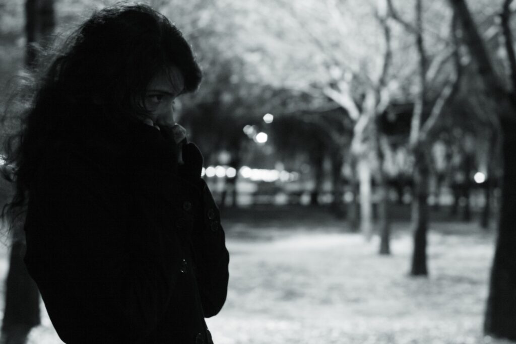 A lonely woman walking at night, hiding her unexpressed resentment toward partner when my girlfriend is cold.