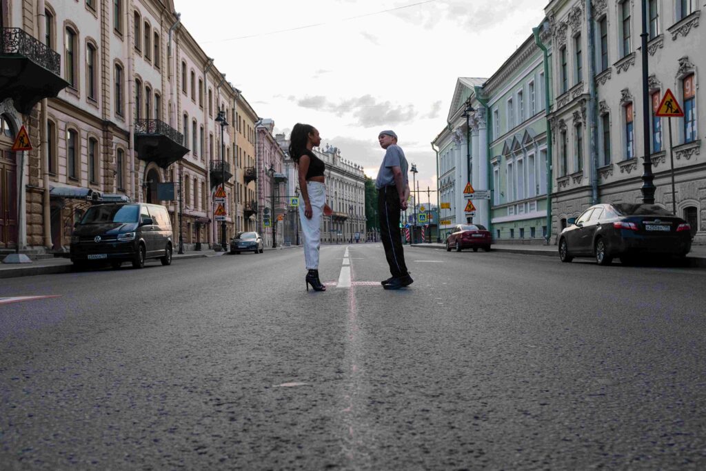 Shadow of a couple holding hands on the ground, representing long term commitment stability stage. 
