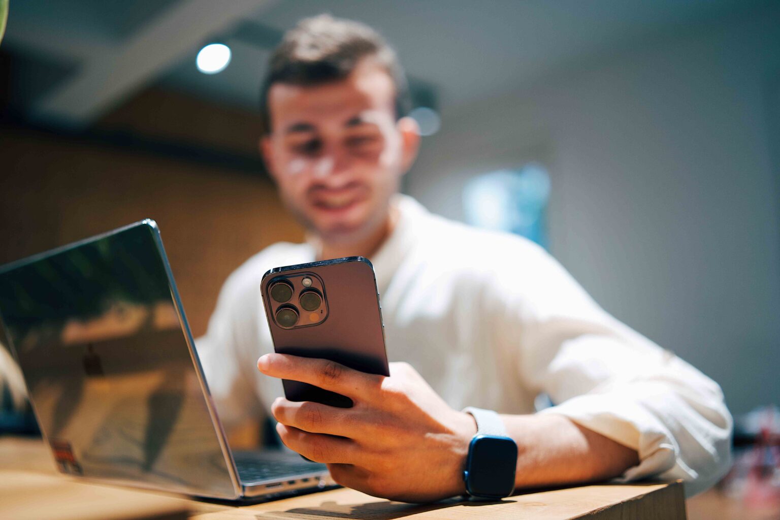 The 10-Second Text That Will Make Him Smile for Hours (Copy & Paste) A man smiling at his phone. The 10-second text that will make him smile.