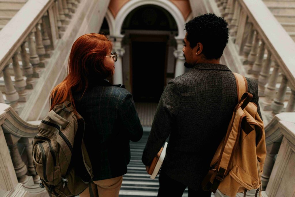 Students walking down stairs, showing what to talk to your crush by sharing survival moments. 