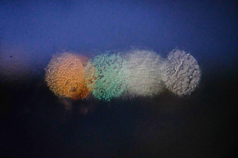 Abstract warm bokeh lights on a window, symbolizing when to say I love you relationship timeline.