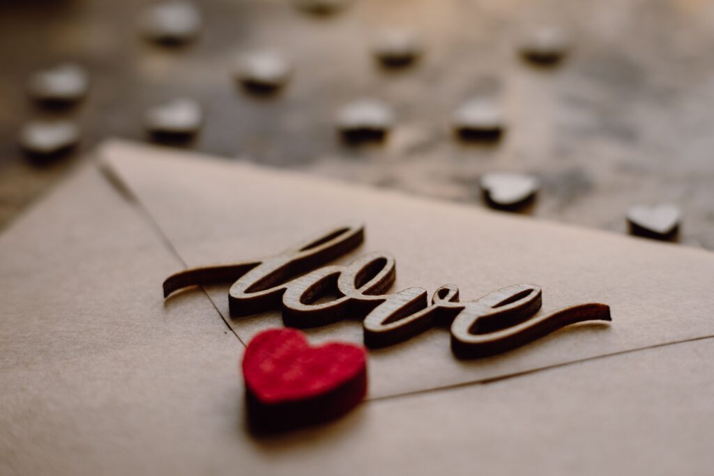 A love letter with a wooden heart sharing powerful love poems for him.