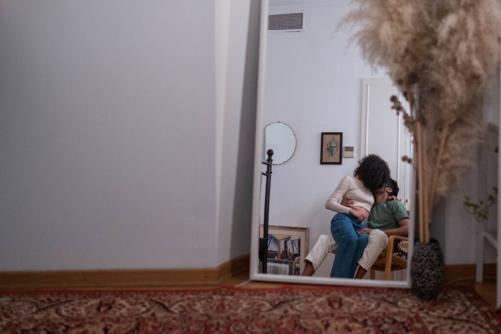 A mirror reflection of a couple, debunking the all or nothing fallacy across physical intimacy stages.