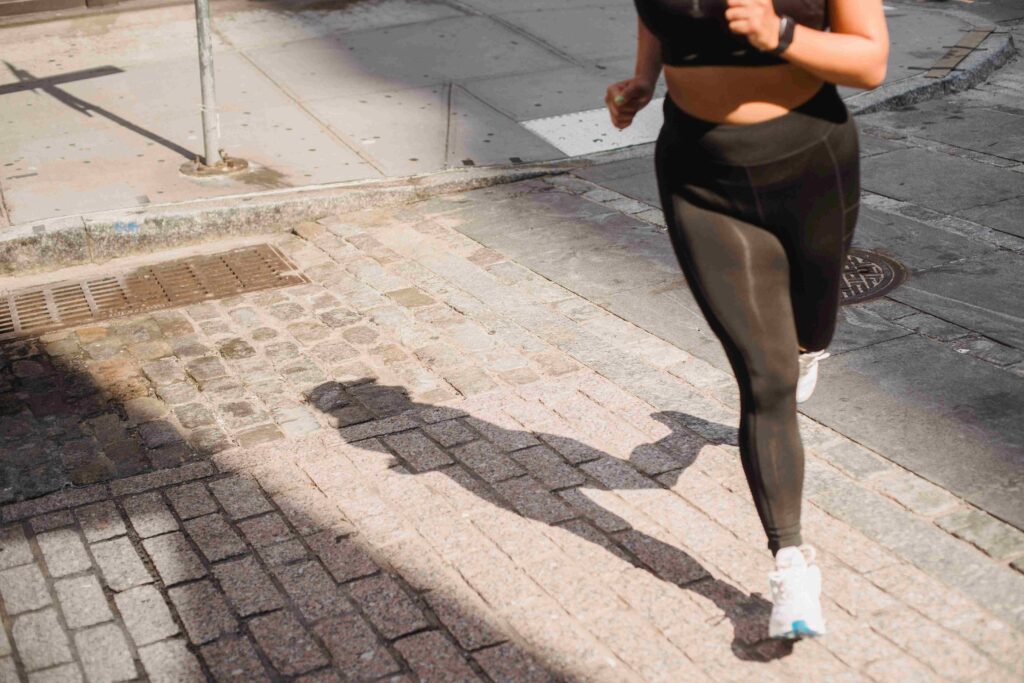 A woman jogging on a city street to clear her head because her husband ignores me at home.