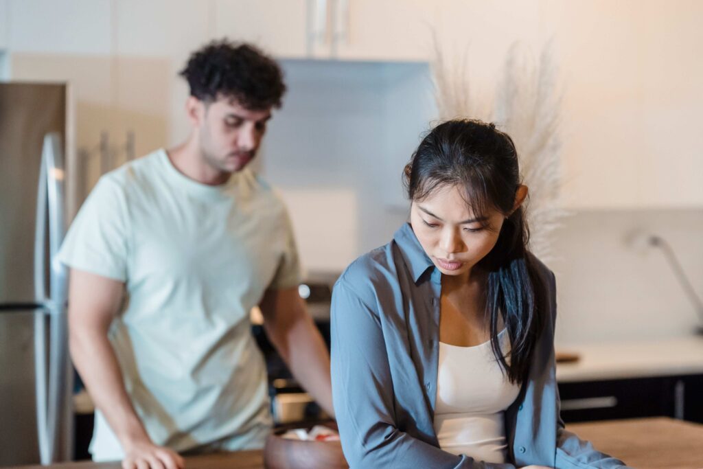 Upset woman turning away from her partner highlighting conflict resolution for couples in daily life. 