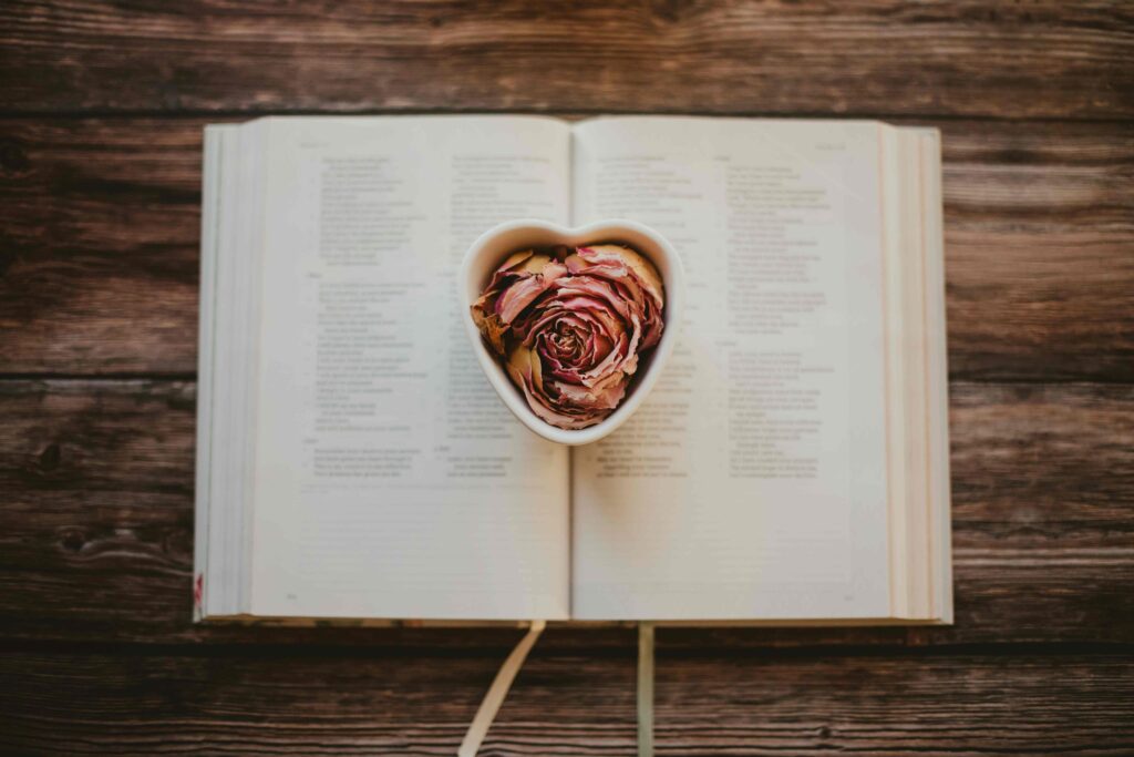 A heart on an open book reflecting the agape love definition in the bible. 