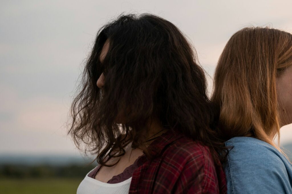 Fake Friends Quotes: 47 Indirect Sayings to Heal from Betrayal A woman resting her head sadly while recognizing fake friends and quiet emotional distance.