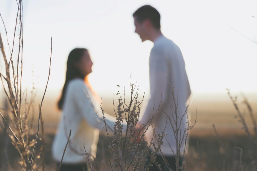 A couple standing outdoors exploring the true kind person meaning.