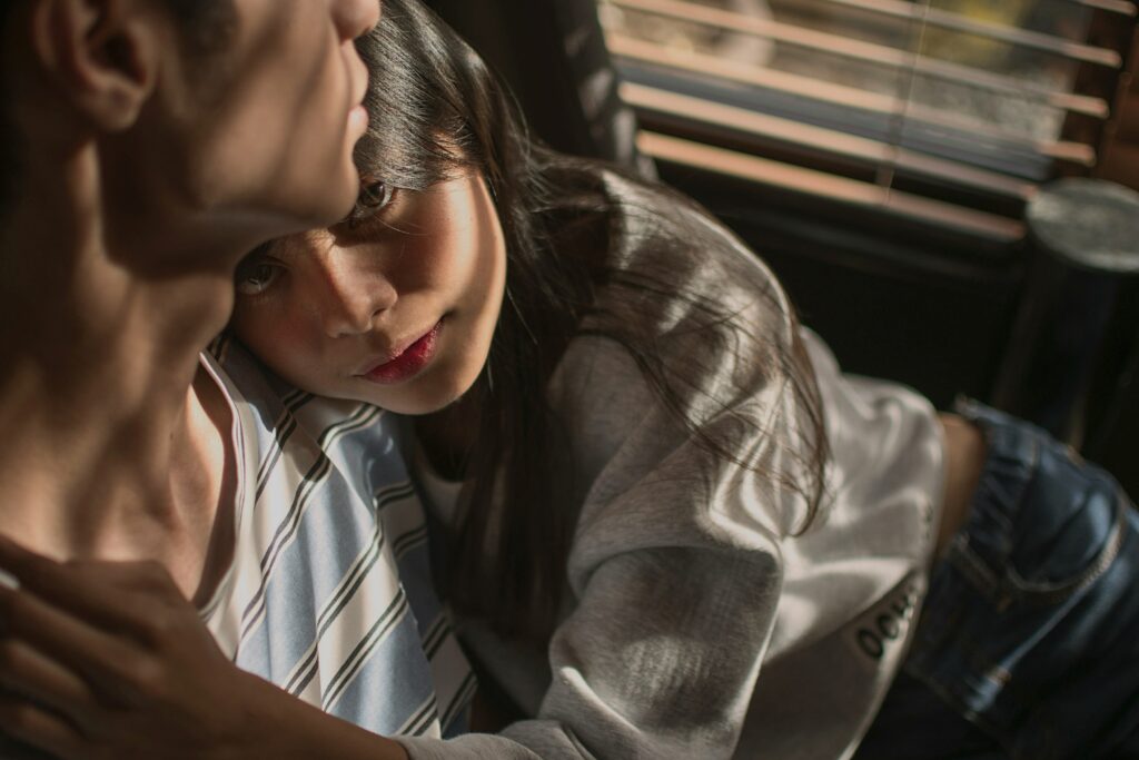 A woman leaning on a partner showing father wound symptoms in female relationships.