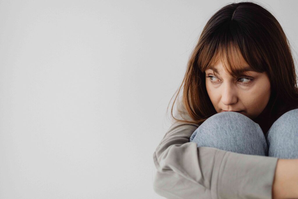 A thoughtful woman reflecting on the difference between nice and kind.