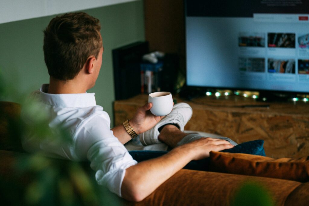 A person relaxing while watching TV dealing with a lack of self identity issue.