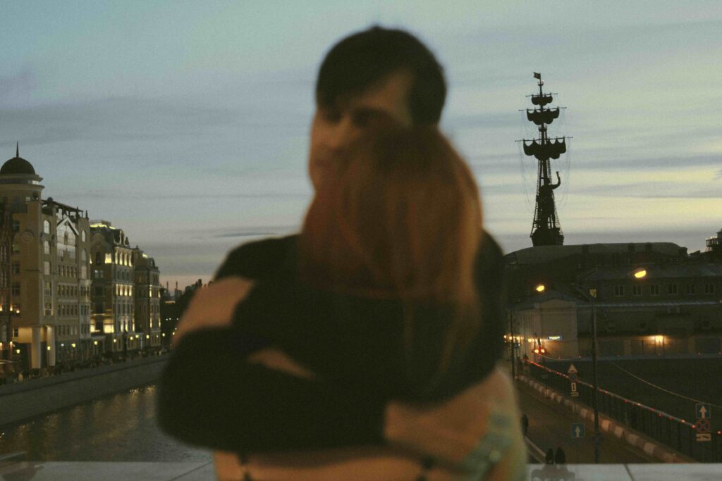 A couple hugging outdoors near a river illustrating self value in romance and boundary setting.