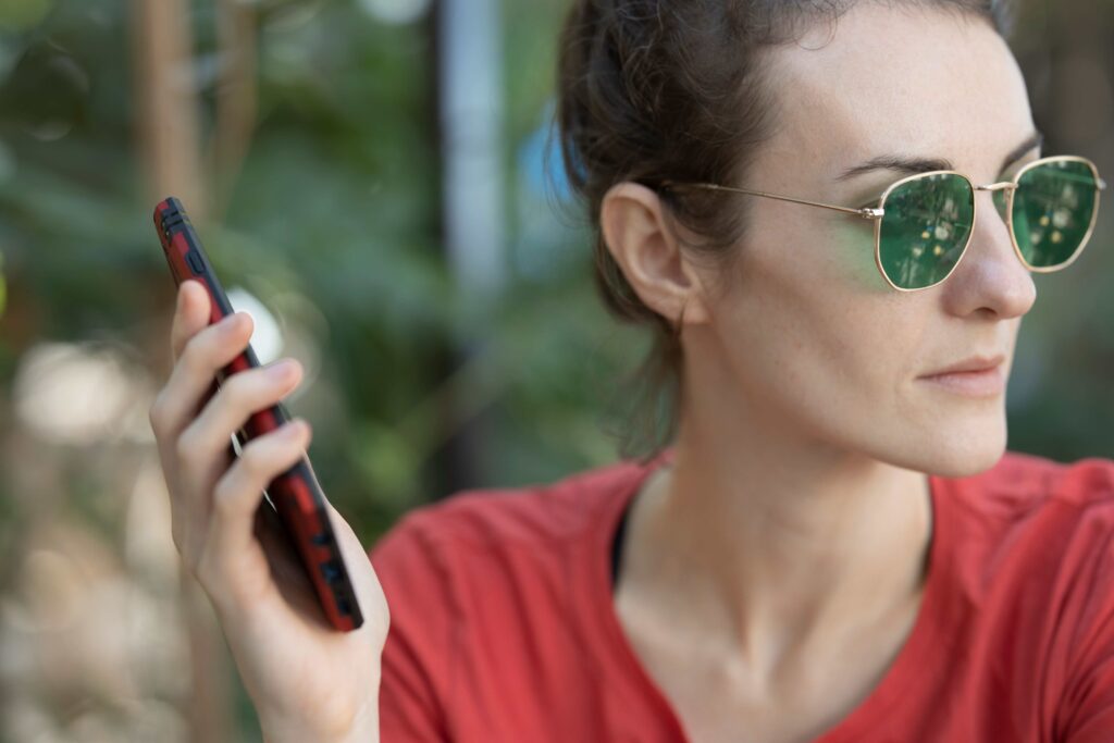 A woman checking her phone while ending the early dating stage politely instead of ghosting.