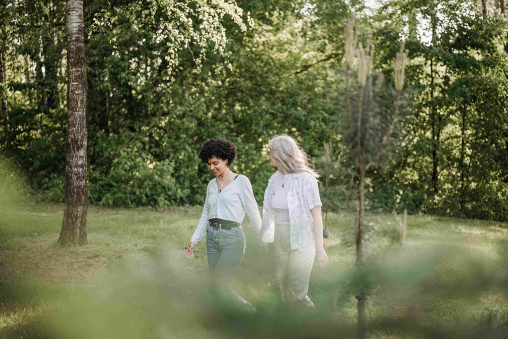 Two women walking together in nature representing like minded soul connection and shared values.