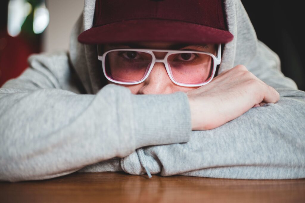 A young person in a hoodie illustrating role confusion symptoms and lack of self.