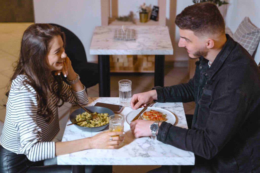 A couple enjoying dinner and expressing themselves openly like a good person.