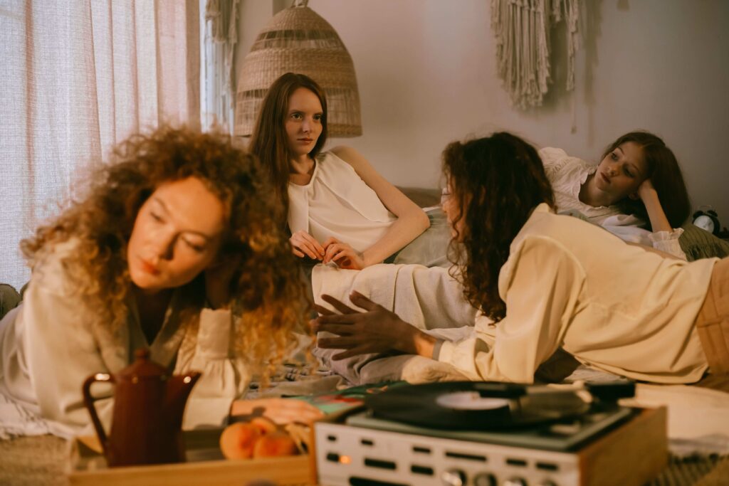 A group of young women gossiping in a room representing toxic relationships. 