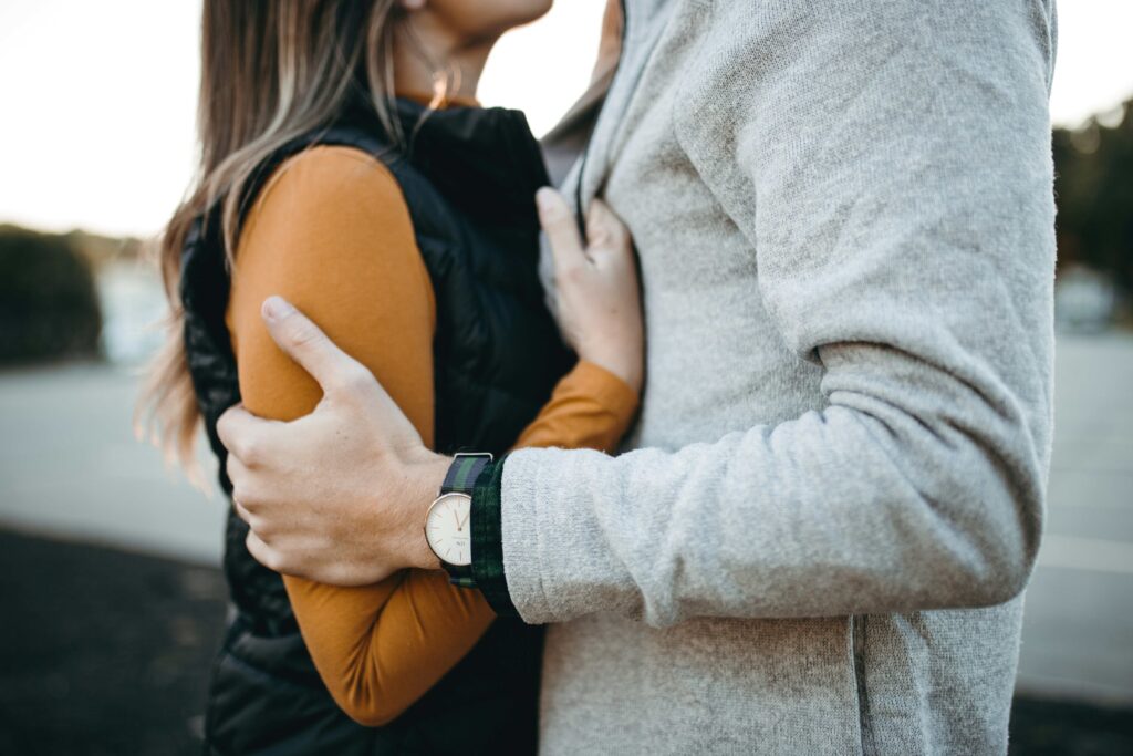A couple hugging tightly understanding what does clingy mean in love.