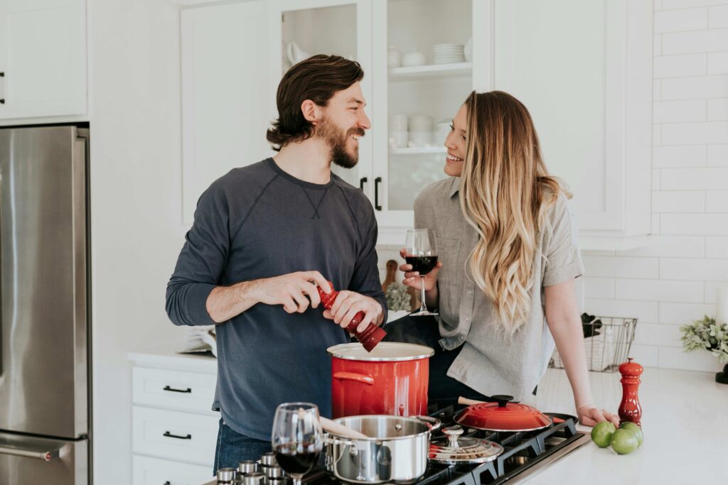 A couple cooking together expressing selfless love in marriage every day. 