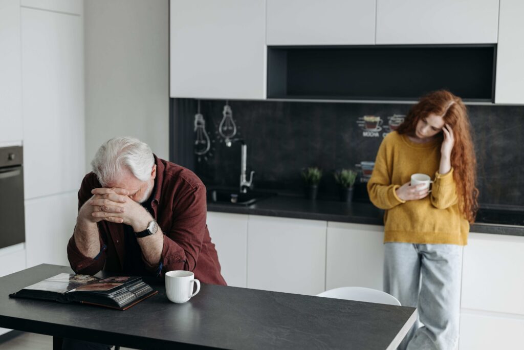 What Are Daddy Issues? The Root Causes & How to Heal in Love A father and adult daughter in distress illustrating what are daddy issues in family dynamics.