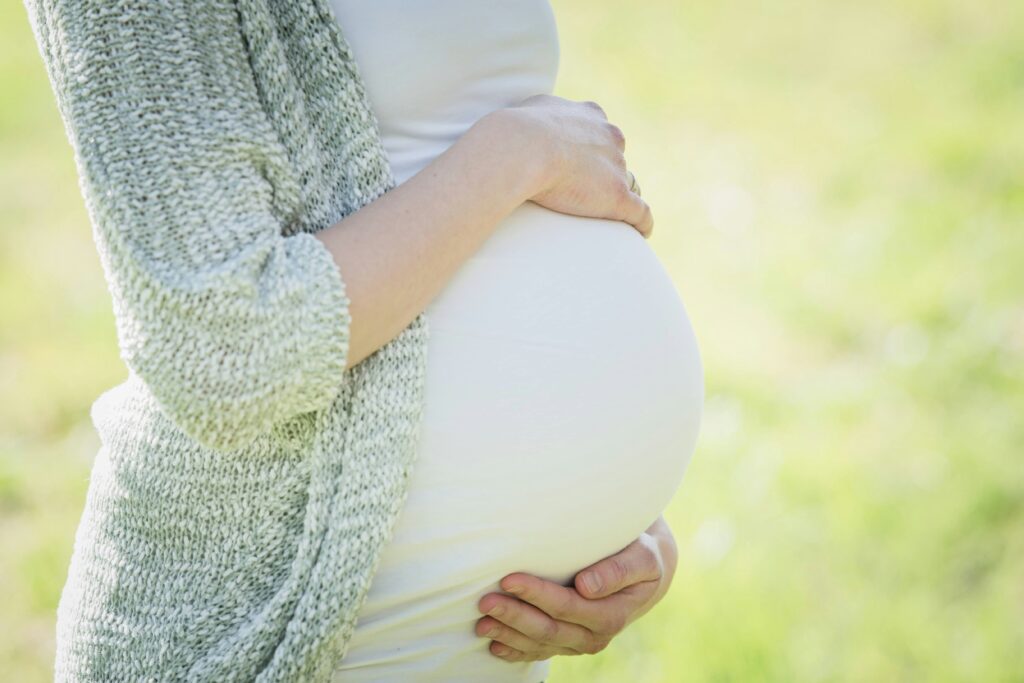 What Does It Mean When You Dream About Being Pregnant? 5 Real Reasons Close up of a pregnant belly showing what does it mean when you dream about being pregnant.