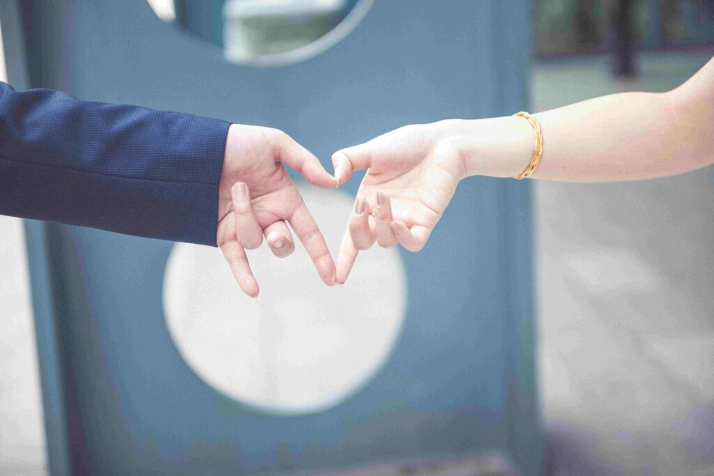 Hands forming a heart shape illustrating what is agape love in a strong marriage.