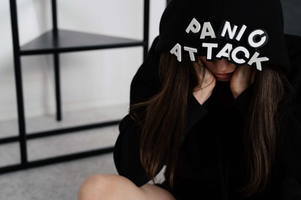 A woman covering her face while wondering why am I so sensitive to small interactions.