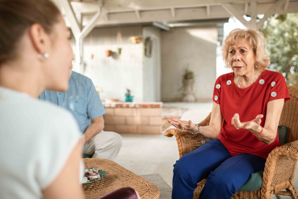 10 Signs You Have a Toxic Daughter-in-Law & How to Respond An older mother talking anxiously showing 10 signs you have a toxic daughter-in-law.