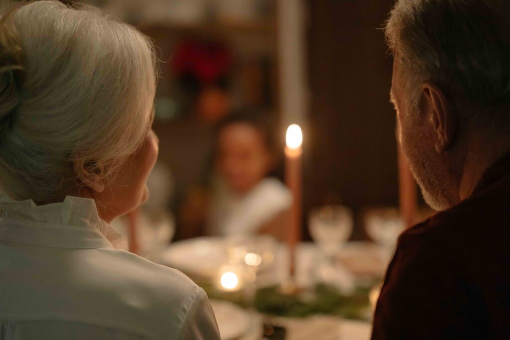 Parents sitting at the dinner table maintaining peace despite toxic in-law behavior.