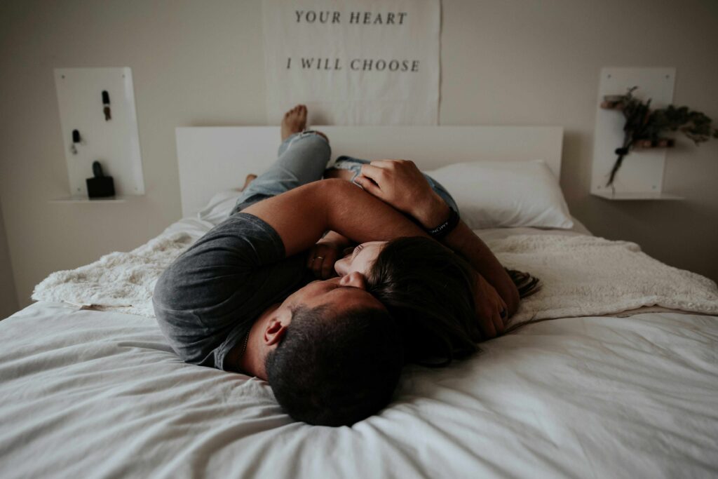 Two lovers lying peacefully together in bed experiencing what is love in a relationship.