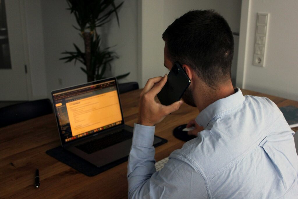 A man talking on phone while typing on laptop showing cognitive processing styles.