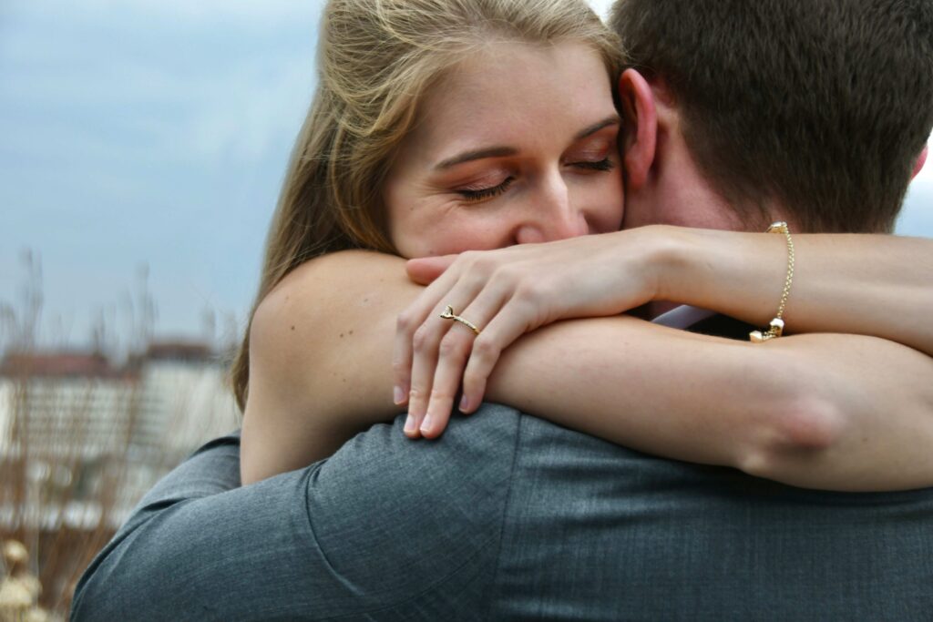 What Does Love Feel Like? 11 Signs You’ve Found Your True Match A couple embracing closely outdoors reflecting what does love feel like in a healthy connection.