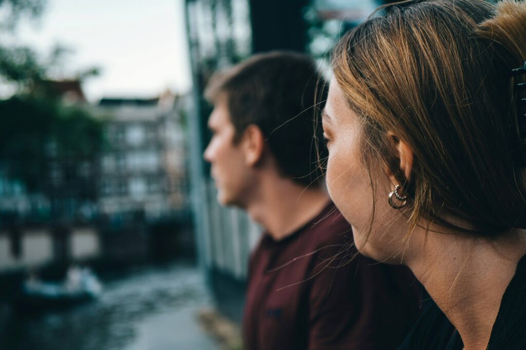 17 Common Nightmares That Are Actually Warnings About Your Relationship A man and woman looking away from each other showing common nightmares that are actually warnings.
