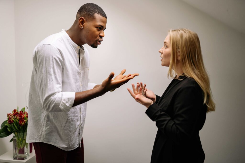 A man and woman having a tense argument over subtle relationship betrayals.